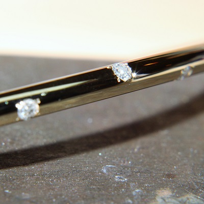 Detail of bead set diamonds on 9k bangle
