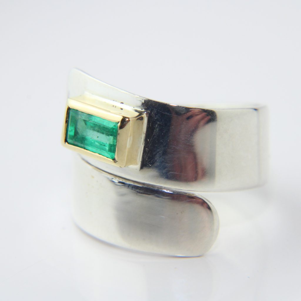 A remade ring. New setting, original band and emerald.