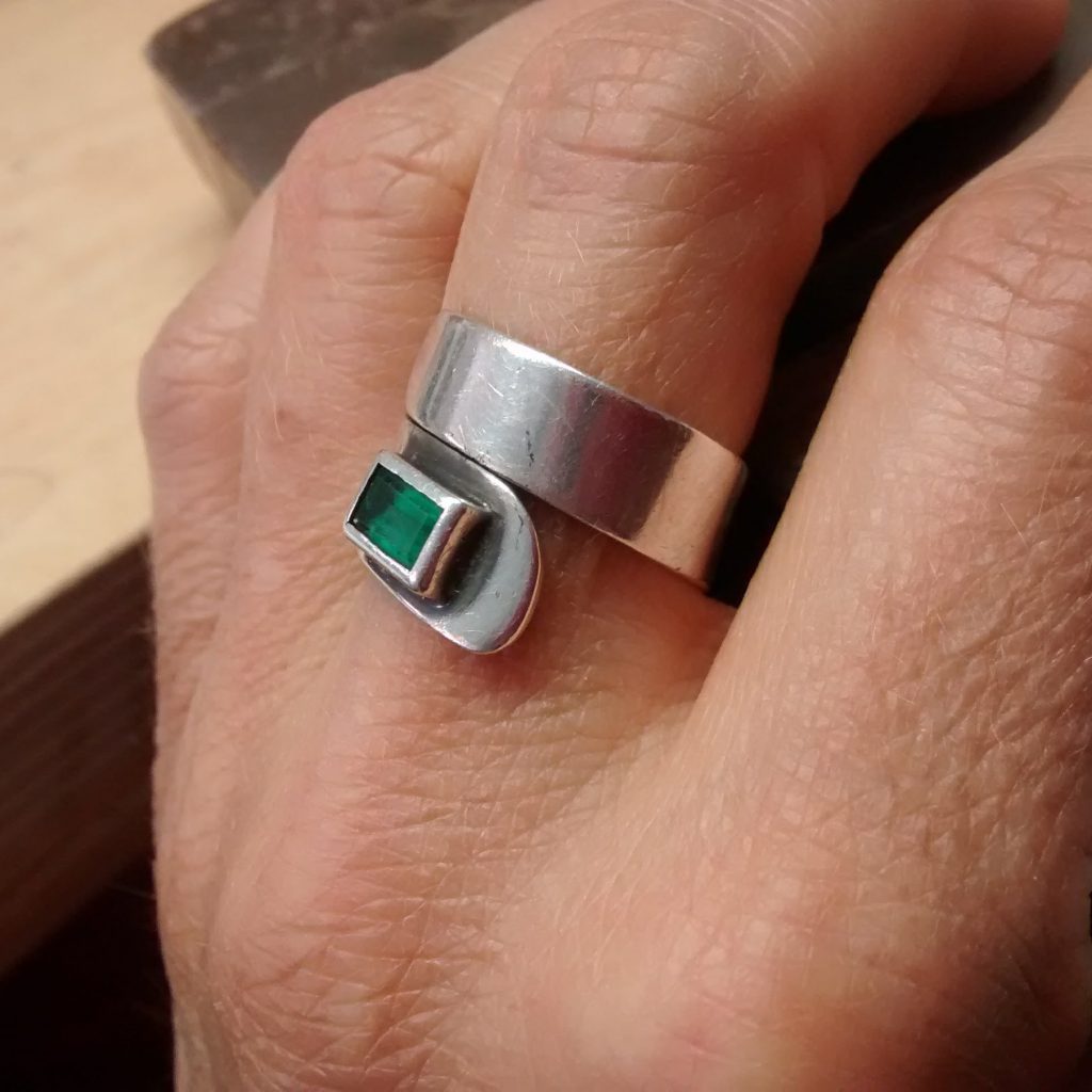 A remade ring. New setting, original band and emerald.