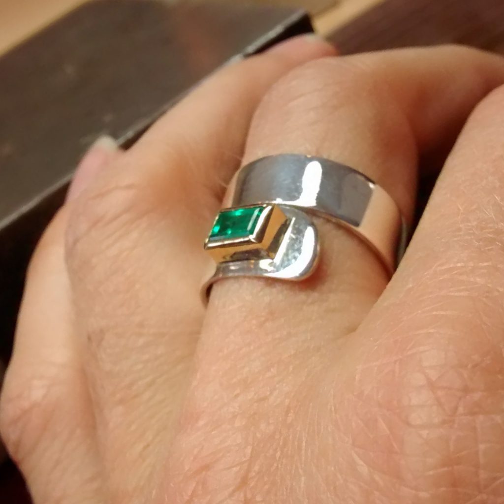 A remade ring. New setting, original band and emerald.