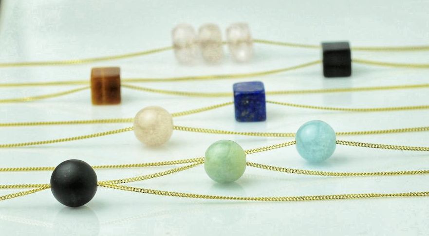 Aurelia - fine 9 karat curb chains sporting gemstone beads .