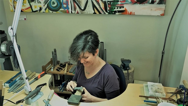 Nicole ban der Wolf at work at the bench in her studio